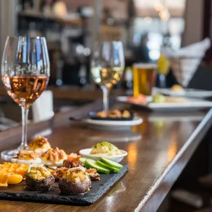 a plate of appetizers and a glass of wine