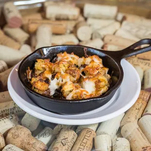 a pan of food on a plate surrounded by corks