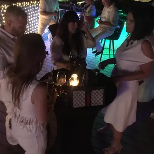 a group of people sitting around a table