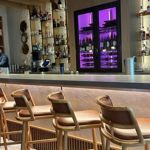 a bar with wooden chairs