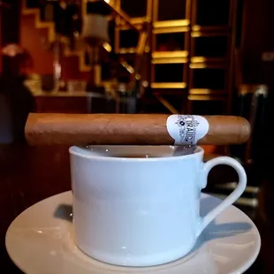 a cigar in a cup