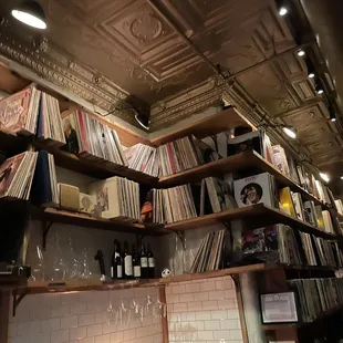 shelves of vinyl records and wine glasses