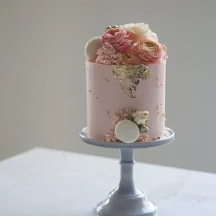 a pink cake with flowers on top