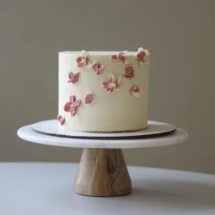 a white cake with pink flowers