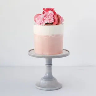 pink ombre cake with fresh flowers and macarons