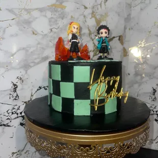 two figurines on top of a cake