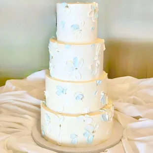 4 tiered wedding cake with pale blue palette knife flowers