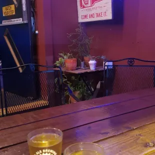 two glasses of beer on a wooden table