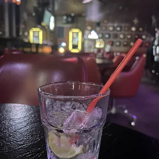 a drink in a glass with ice and a straw