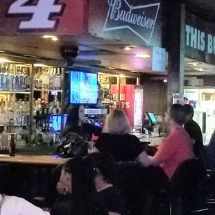 Long, dark haired Bartendress is professional, informative, empathetic; has good customer rapport. Bravo!