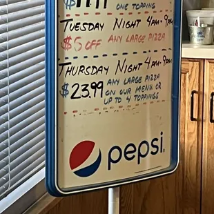 a pepsi sign in a kitchen