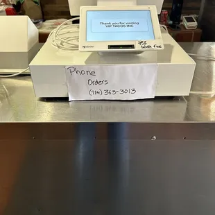 a cash register and a bottle of water