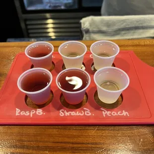 a tray with cups of wine
