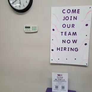 a purple table with a sign that says come join our team now hiring