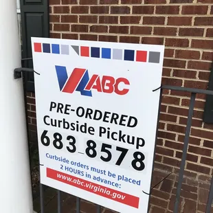 a sign for a pre - ordered curbside pickup