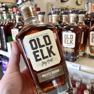 a hand holding a bottle of old elk