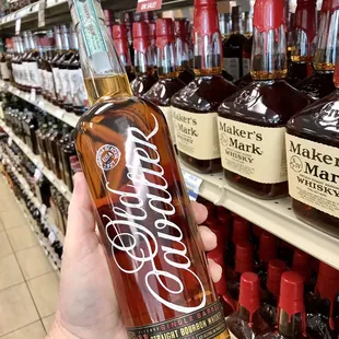 a hand holding a bottle of brandy