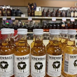 a row of small bottles of whiskey