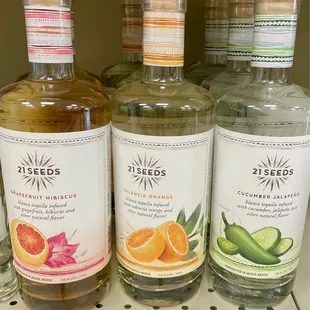 three bottles of orange and cucumber gin