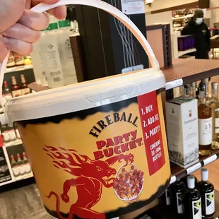 a person holding a bucket of food