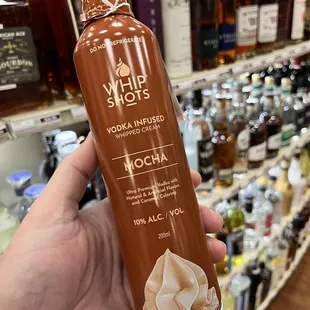 a hand holding a bottle of mocha