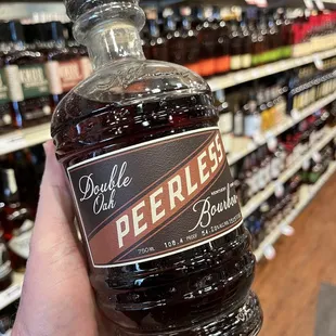 a hand holding a bottle of beer