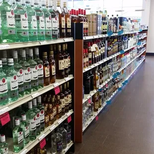 a grocery store aisle filled with bottles of alcohol