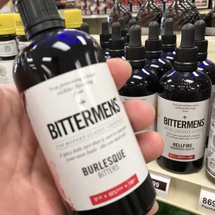 a hand holding a bottle of bittermen's
