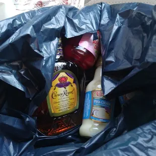a bottle of honey and a bottle of ketchup in a blue bag