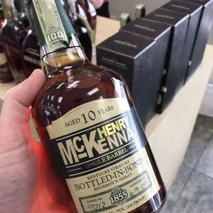 a person holding a bottle of whiskey