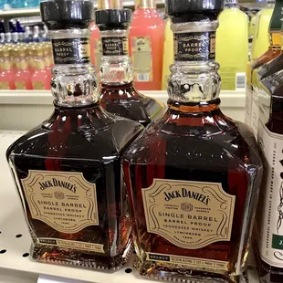 three bottles of whiskey on a shelf