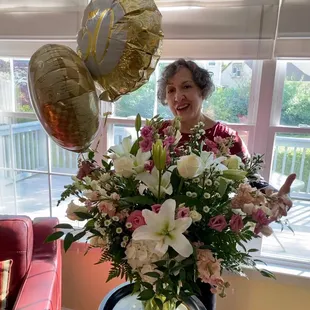 My mom thoroughly enjoying her flowers.