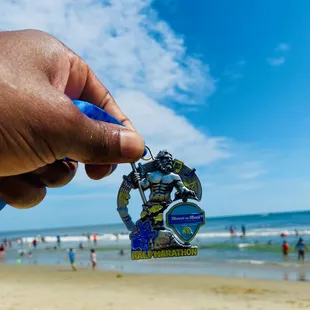 Post Va Beach Half Marathon medal "bragging" on the beach.
