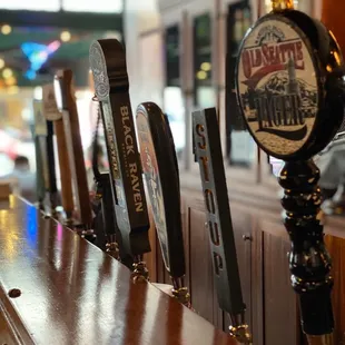 a row of beer taps on a bar