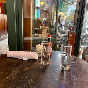 a glass of water and a napkin on a table