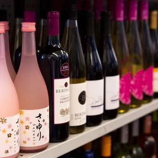 a row of wine bottles on a shelf