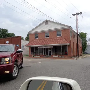 a view of a red truck parked in front of a red brick building