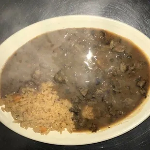 a plate of food with gravy and rice