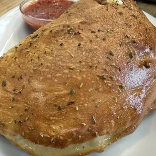 Cheese and mushroom calzone with tomato sauce