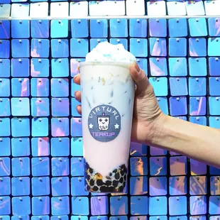 a hand holding a cup of bubble tea