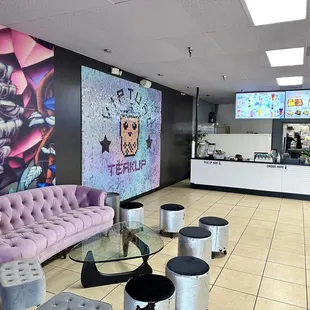a coffee shop with a large mural on the wall