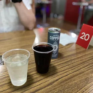 a cup of coffee and a can of coffee