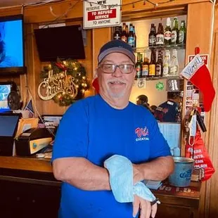 a man in a blue shirt and gloves