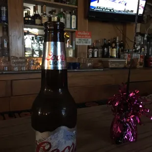 a bottle of beer on a bar counter
