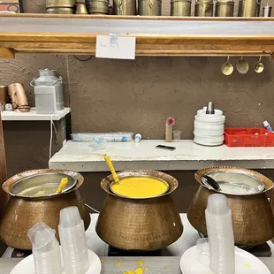 three bowls of soup on a table
