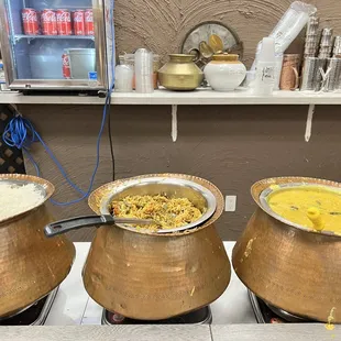 three bowls of food on a stove