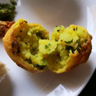 Vada. Spiced potatoes coated with chickpea flour and fried. Vegan