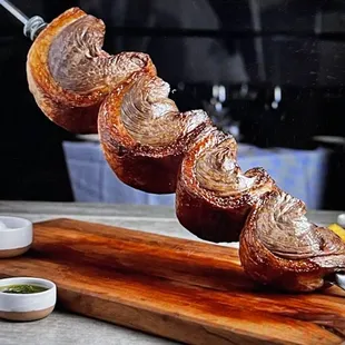 a pork skewer on a cutting board
