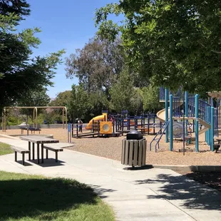 Swings, children's playground, benches all in this center space.