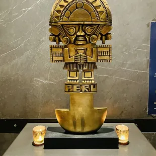 a gold sculpture on display in a museum